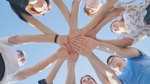 friends putting their hands together in a sign of unity and teamwork