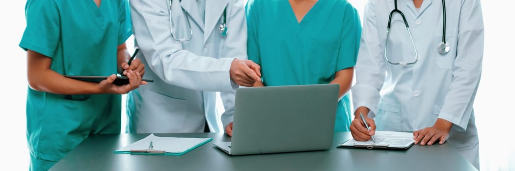 Doctor and nurse in medical meeting discussing strategic medical treatment plan together with report and laptop. Medical school workshop training concept in panoramic banner. Neoteric