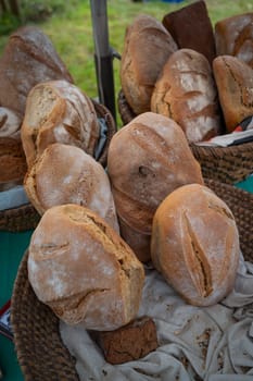 Pile of freshly baked wholemeal breads in the bakery or local farmer market, High quality photo