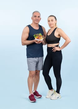 Happy smile senior man and woman portrait holding bowl of vegan fruit and vegetable on isolated background. Healthy senior couple with healthy vegetarian nutrition and body care lifestyle. Clout