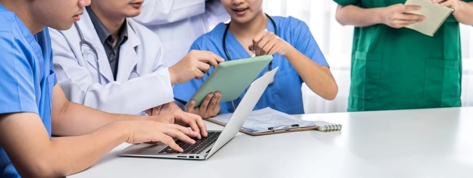 Professional various team of medical working and planning medical treatment at hospital table together. Teamwork lead to successful illness and sickness treatment. Panorama Rigid