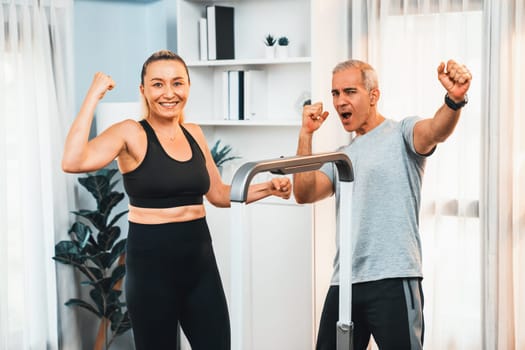 Athletic and sporty senior couple portrait in sportswear with successful or celebrating after overcome struggle posture as home exercise concept with healthy fit body lifestyle after retirement. Clout