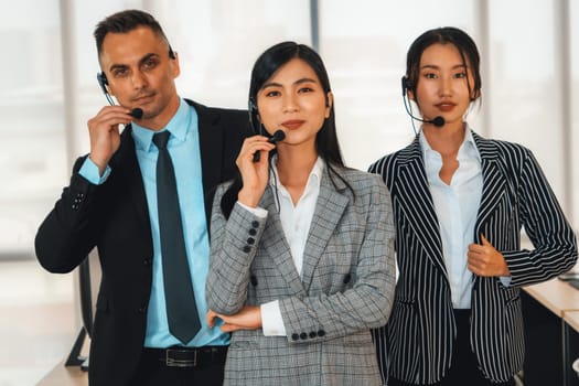 Business people wearing headset working in office to support remote customer or colleague. Call center, telemarketing, customer support agent provide service on telephone video conference call. Jivy