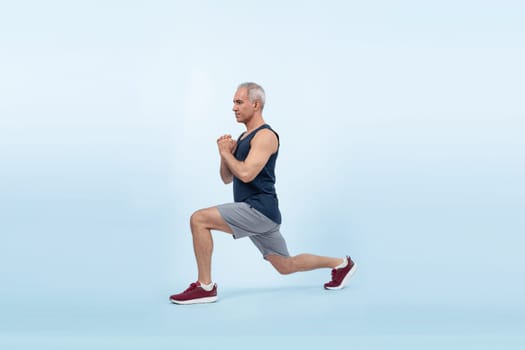 Active and fit physique senior man warming up before exercise on isolated background. Healthy lifelong senior people with fitness healthy and sporty body care lifestyle concept. Clout