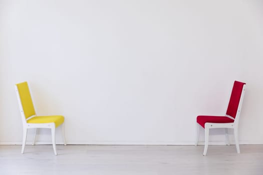 Two chairs in the interior of an empty white room