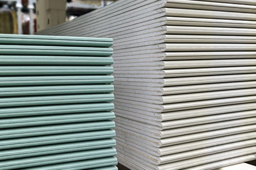 Drywall sheets stacks. Plasterboard sheets are stacked on top of each other. Construction and repair material. Closeup view.