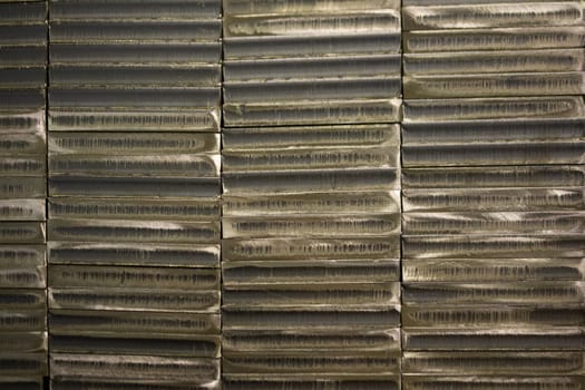 stack of laser cut steel billets - closeup texture and background.