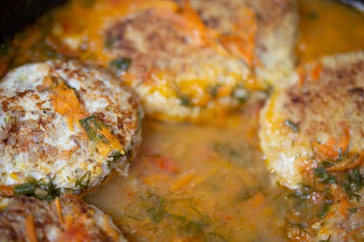 delicious chicken cutlets fried in a frying pan with gravy, unadorned real life closeup photo with selective focus