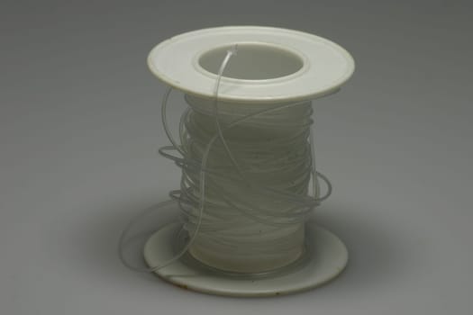 Clear thread on white plastic roll