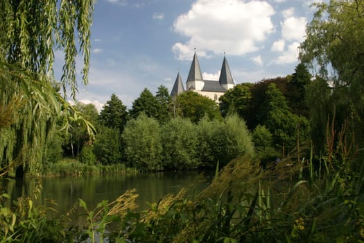 View over a lake to the imperial cathedral in Königslutter am Elm