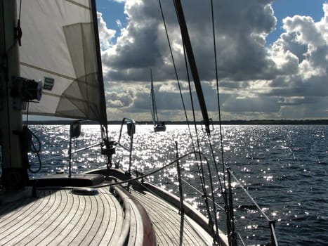 On the way to Sønderborg,sailing weather at its finest. This time backlight and oncoming traffic Boat type Vindö 50,an old lady,built in 1977,shipyard Vindö/Sweden. The planks are made of teak,the superstructure is mahogany and the hull is made of GRP.