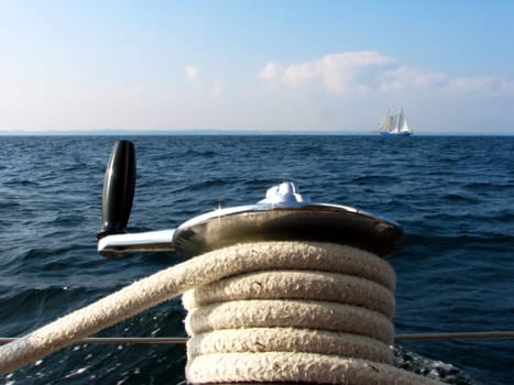 In the foreground is the winch,which is used to seal the foresail (jib). The person who serves them is called a jib monkey,but someone should say that to me  -) "Fock monkey is a colloquial variant for the foresheet in a"