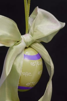 Easter egg,hanging,against a black background
