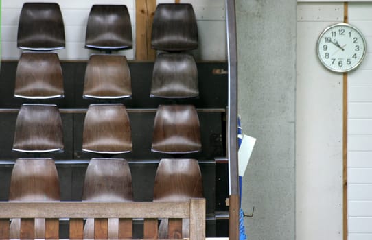 Empty spectator stands with wall clock