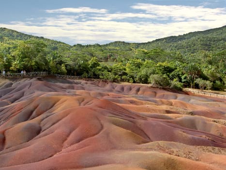 On the island of Mauritius,near the village of Chamarel,there is a place where the bare earth is exposed,there is no vegetation and the earth shines strangely in different colors. The earth is of volcanic origin,and the color results