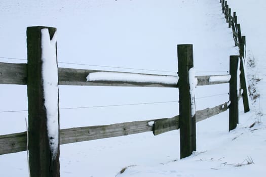 snowy wooden fence