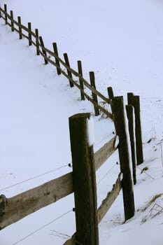 snowy wooden fence