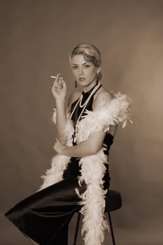 A woman dressed in the style of the 20s sits on a bar stool with a cigarette.