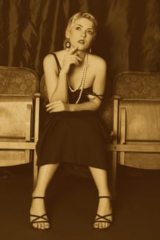 A woman in the style of the 20s sits thoughtfully in the cinema