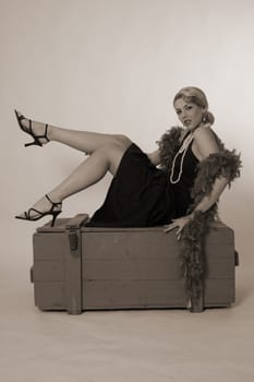 A woman in the style of the 20s sitting on an ammunition box with outstretched feet