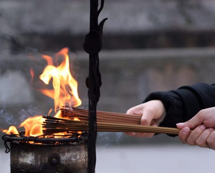 Ignition of incense sticks for a Buddhist prayer,recorded in a temple in China