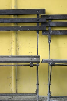 Folding chairs in front of a yellow wall