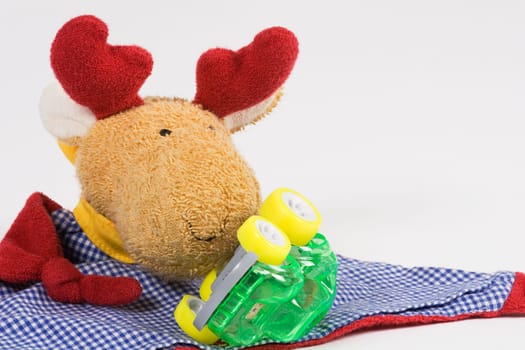Moose test stuffed moose in front of which lies a fallen car