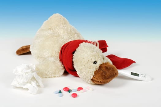 Duck lying on floor with clinical thermometer and tablets