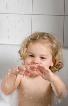 Child surrounded by drops while bathing