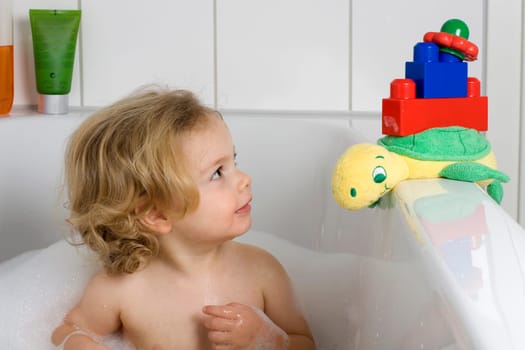 Child bathing with toys