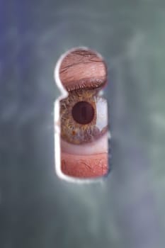 Eyes through a keyhole where the keyhole is reflected again in the pupil