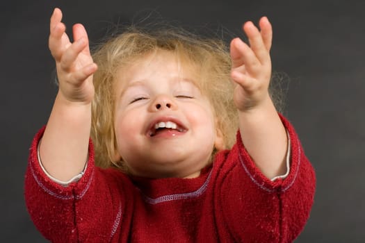 Child stretches his arms to the sky
