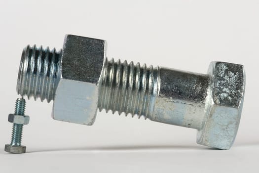 a large screw is supported by a small screw