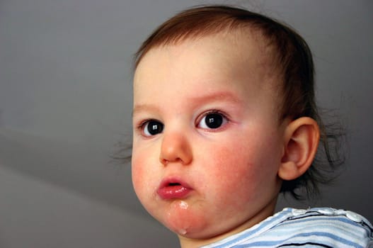 Levy,my niece's son,looks with his big,brown eyes and pulls a snout...