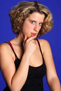 Photo shows a woman with fingers resting on her lips