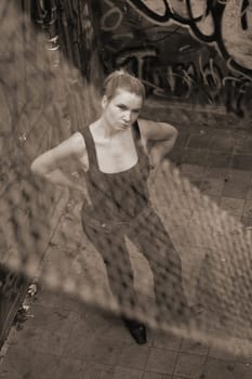 Woman standing in a building full of graffiti
