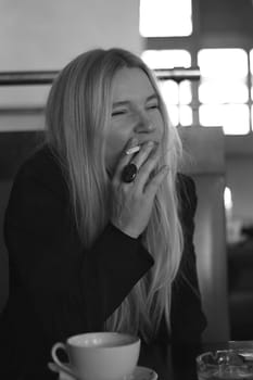 Woman sitting smoking in café