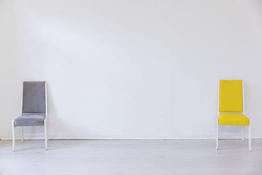 Two chairs in the interior of an empty white room