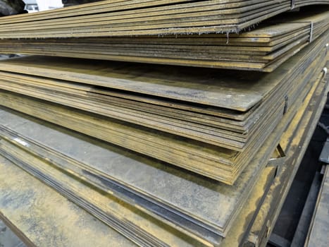 thick rusty hot rolled steel sheets stack corner, close-up.