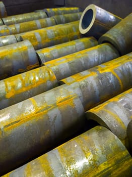 rusted thick steel pipe chunks after sawing waiting for machining operations.