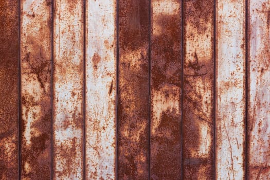 flat texture and full-frame background of rusty corrugated flat thin sheet metal surface with vertical structure and leftovers of white paint.