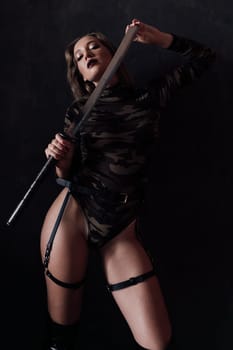 woman with a katana in military clothes on a black background