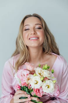 woman in pink dress with flowers in the room for a holiday