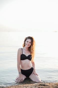 woman in black swimsuit on the beach leisure walk