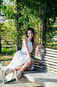 woman sitting on a bench for a walk in the park on the street