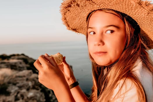 Portrait of young beautiful girl eating corn. Snacking on the sea