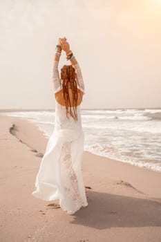 woman sea white dress. Model in boho style in a white long dress and silver jewelry on the beach. Her hair is braided, and there are many bracelets on her arms