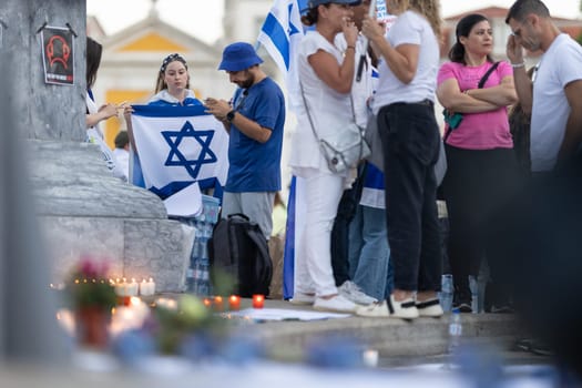 Lisbon, Portugal – October 10, 2023: People with the Israel flags standing at the memorial to the fallen Israelis in October 2023. Mid. shot