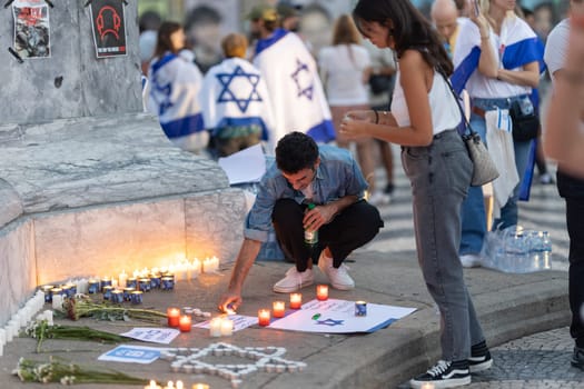 Lisbon, Portugal – October 10, 2023: People light candles at the memorial to the fallen Israelis in October 2023. Mid. shot