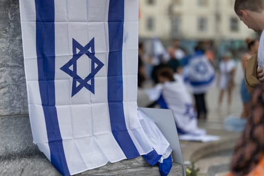 Lisbon, Portugal October 10, 2023. The flag of Israel in close-up on the background of a rally in support of Israel. Mid.shot